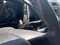 A 2016 Ford Transit dashboard with speedometer and control stalk for turn signals and wipers in focus