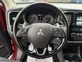 Image of a 2016 Mitsubishi Outlander steering wheel with control buttons and a Mitsubishi logo in the center