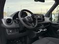 Interior view of a 2019 Mercedes-Benz Sprinter showing the steering wheel dashboard and central control console with cup holders
