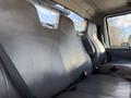 The interior of a 2017 International 4300 featuring leather seats with seatbelts visible and a spacious back seat area