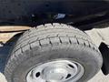 Close-up of a tire on a 2016 Ford F-250 SD featuring a rugged tread pattern and a silver wheel rim