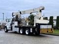 2004 Sterling LT9500 crane truck with a National Crane boom mounted on the rear and distinctive black and yellow striped bumper