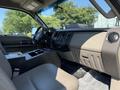 Interior of a 2008 Ford F-550 with gray seats and dashboard featuring the Super Duty logo and a center console area