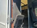 A 2012 Ford E-450 driver's seat is visible with a fabric cover and adjustable controls on the side
