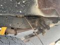 Undercarriage of a 2014 Ford F-250 SD showing suspension components and rusted metal parts