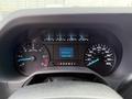 Dashboard of a 2022 Ford E-450 showing speedometer tachometer and digital display with mileage and trip information