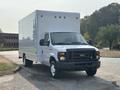 A white 2008 Ford Econoline box truck parked with a front view showcasing a large cargo area and a simple grille design