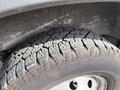 A close-up of a worn tire on a 2017 RAM Promaster showcasing the tread pattern and sidewall details