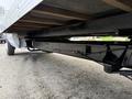 A 2022 Ford E-450 chassis showcasing the undercarriage with black metal framing and support beams