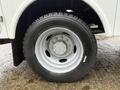 Close-up of a silver wheel and tire assembly from a 2015 Ford F-450 featuring a multi-spoke design and heavy-duty tread pattern