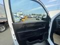 The interior view of a 2016 RAM 5500 truck with an open driver's side door showcasing the door panel and side mirror