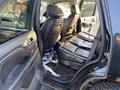 Interior of a 2007 Cadillac Escalade showing black leather seats and scattered items on the floor