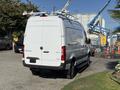 A 2023 Mercedes-Benz Sprinter 2500 van with a white exterior featuring a roof rack and a sleek design