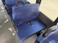 A blue fabric seat inside a 2020 Chevrolet Express with a seatbelt attached and a sturdy handle on the top