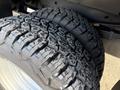 Close-up of two rugged tires with deep treads designed for a Ford F-350 showcasing their textured surface and sturdy build