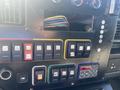Close-up of the dashboard controls in a 2011 Chevrolet Express featuring various switches and buttons for lights and functions