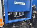 Blue container labeled PLASTICS ONLY with metal hoses and valves visible inside
