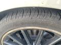Close-up of a black alloy wheel with a high-performance tire showing tread pattern on a 2014 Mercedes-Benz CLA-Class
