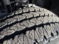Close-up of a tire tread from a 2023 RAM 3500 showcasing deep grooves and a rugged design for traction and durability
