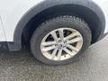 Close-up of a wheel and tire of a 2016 Ford Explorer showing a silver alloy rim and rugged tire tread