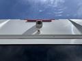 The image shows the rear view of a white 2020 Chevrolet Express with a camera and red light mounted on the upper section of the vehicle