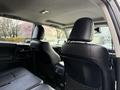 Interior view of a 2021 Toyota 4Runner showcasing two black leather front seats and headrests with a console visible between them