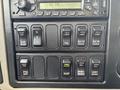 Control panel of a 2013 International WorkStar featuring various switches and buttons for functions like engine brake differential lock dump and PTO engagement