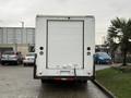 A white 2018 Ford E-450 box truck viewed from the rear with a smooth surface and rear doors closed