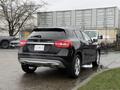 A 2016 Mercedes-Benz GLA-250 in black parked with its rear view visible showing the model name and taillights