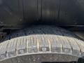 Close-up of a tire from a 2019 Ford Transit 350 showing detailed tread patterns and fine debris on the surface