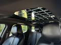 Interior view of a 2023 Fisker Ocean showing the front seats and a panoramic sunroof with a grid design on the ceiling