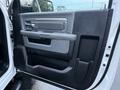 The interior driver's side door of a 2018 RAM 5500 displaying a black and gray panel with a door handle storage compartment and speaker grille