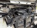 The image shows the engine compartment of a 2012 Ford Econoline with visible components like wires battery and various engine parts