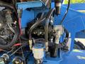 Close-up view of the hydraulic system components on a 2012 Genie Z 45/25 including hoses pumps and valves in a blue metal frame