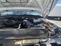 Engine compartment of a 2016 Ford F-350 SD showing various components including hoses and a coolant reservoir