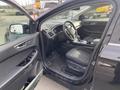 Interior of a 2017 Ford Edge showing the driver’s side with black upholstery and silver accents on the door and dashboard