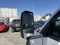 A 2020 Chevrolet Express with a focus on the driver's side mirror reflecting nearby vehicles