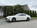 A white 2016 Maserati Ghibli parked with distinctive curves and sleek design showcasing its elegant features and sporty wheels