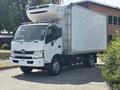 A 2018 Hino 195 truck with a refrigerated box and a white exterior parked on a driveway