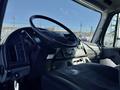 Interior view of a 2017 Freightliner M2 106 showing the steering wheel dashboard and driver's seat
