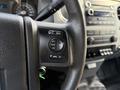 Steering wheel with audio controls of a 2015 Ford F-550 featuring buttons for media volume seek and OK