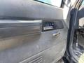 Interior door panel of a 1996 GMC Top Kick showing a textured black surface and a chrome door handle with a missing lock knob