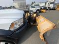 A 2016 RAM 5500 truck with an attached yellow snow plow in the foreground