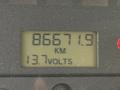 Digital display showing 86671.9 KM and 13.7 volts on a dashboard of a 2005 Freightliner M2 106