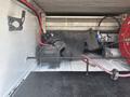 A 2017 Chevrolet Colorado truck with various mechanical components and equipment stored in the bed
