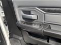 Close-up of the door handle and control panel of a 2021 RAM 5500 showing buttons for window control and handle design