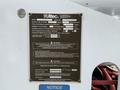 A metal label with specifications and warnings for an Altec lift model LRV552, including capacity, operating temperature, and electrical insulation information