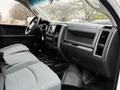 Interior of a 2013 RAM 3500 with grey fabric seats and a black dashboard featuring controls and an infotainment system