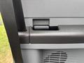 Detail of the interior door handle of a 2013 Ford F-250 SD with textured black finish and gray trim