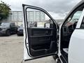 A 2013 RAM 1500 with its driver's side door open showcasing the interior door panel and controls